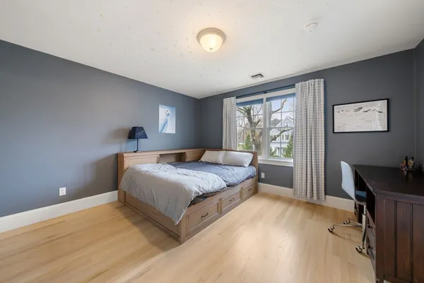 a bedroom with a bed and a desk