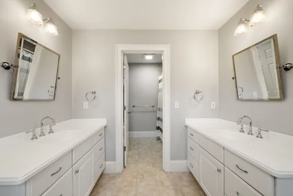 a bathroom with a double vanity sink mirror and