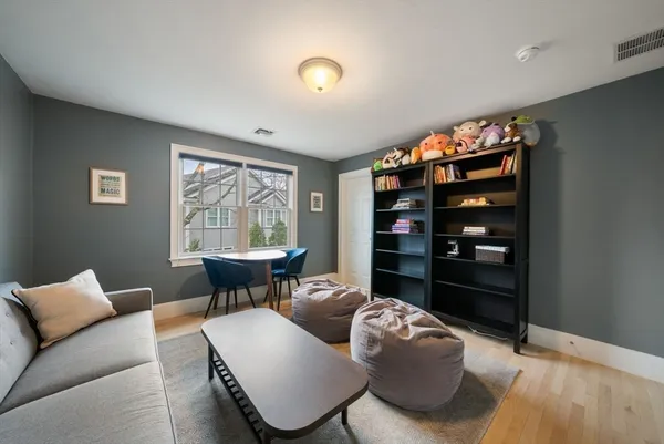 a living room with furniture a window and a table
