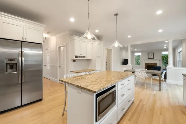 a kitchen with kitchen island a counter top space a sink appliances and cabinets