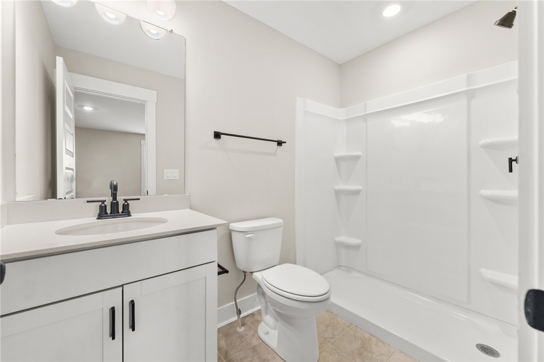 334 Summerall Drive Anderson, SC 29621 - Photo 16 of 28 This functional bathroom features a single vanity, a toilet, and a convenient shower with built-in shelving.