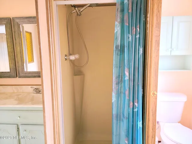 a bathroom with a shower and a toilet