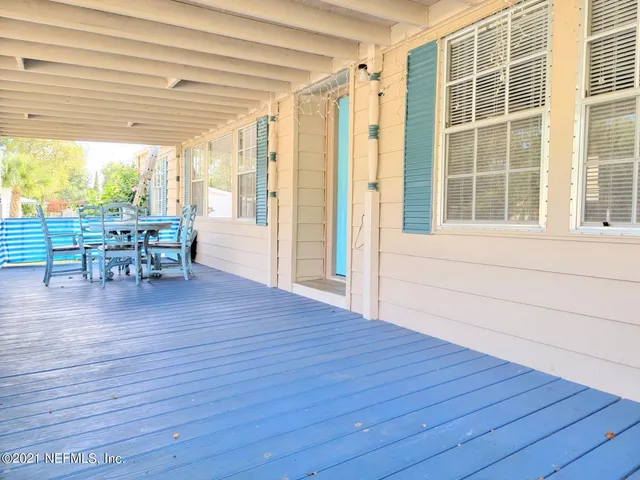 a view of a porch with wooden floor and furniture