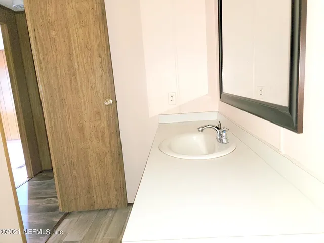 a bathroom with a sink and a mirror