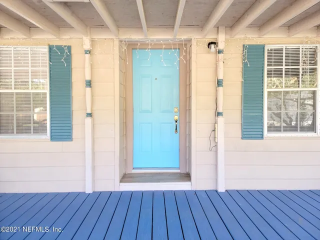 a view of a room with wooden floor and windows