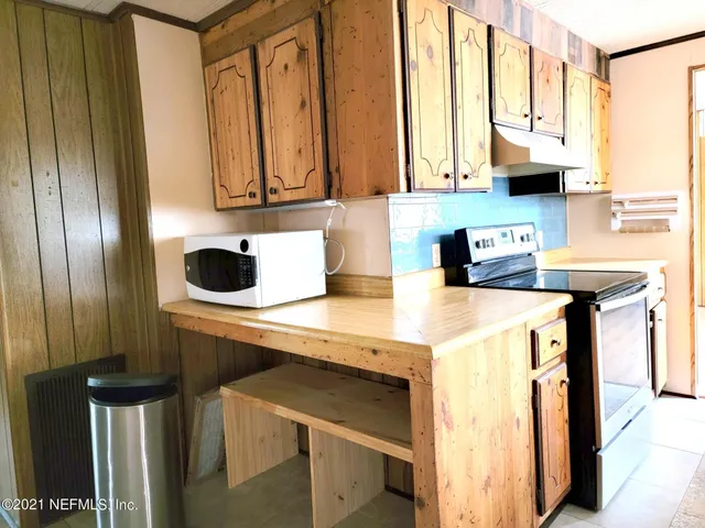 a kitchen with stainless steel appliances a stove a sink and a microwave