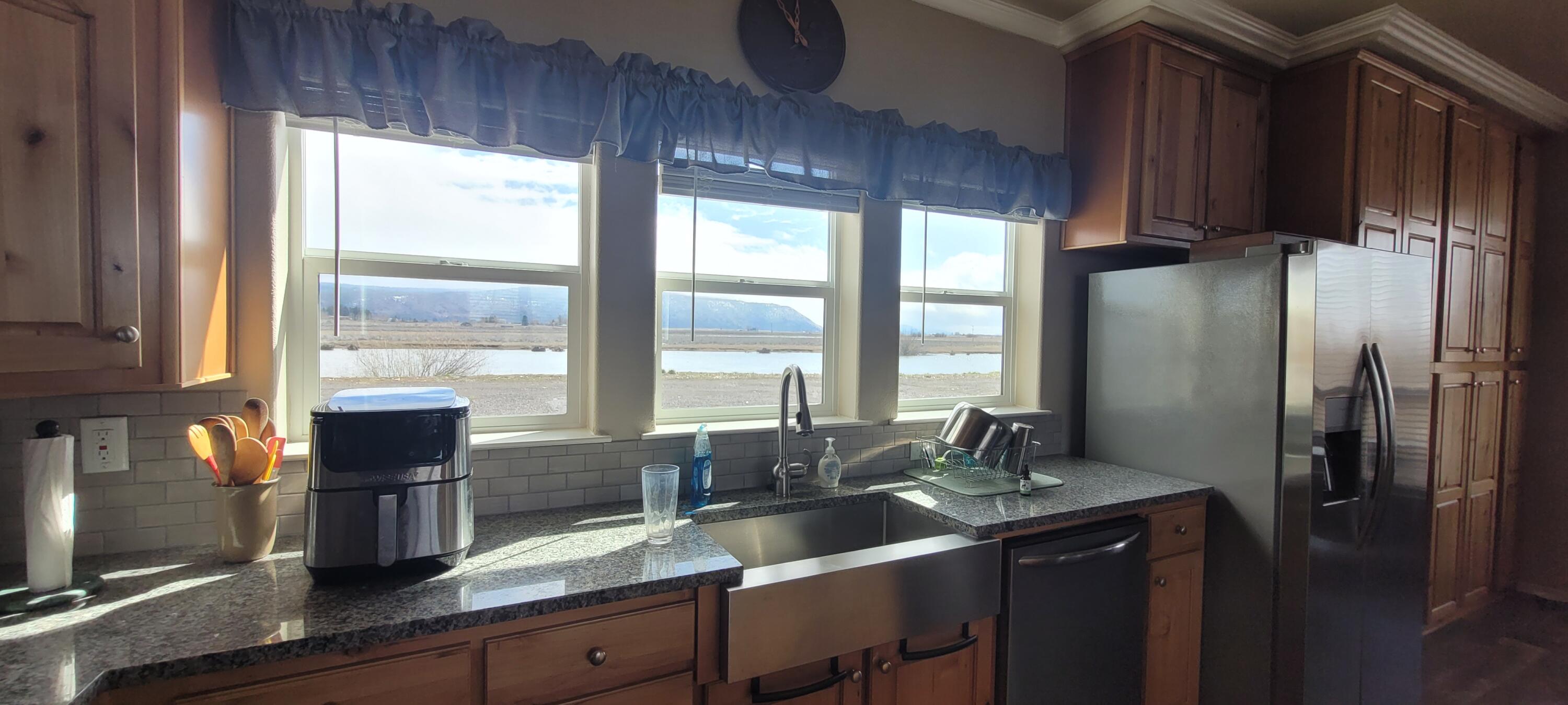 32158 Modoc Point Road Chiloquin, OR 97624 - Photo 6 of 37 a kitchen with stainless steel appliances a sink window and cabinets