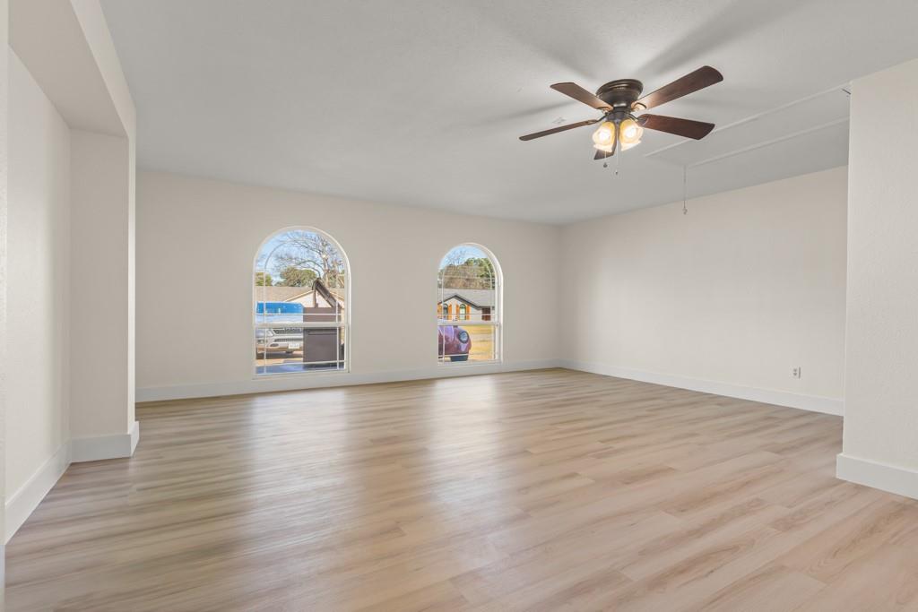804 Alta Street Longview, TX 75604 - Photo 8 of 20 wooden floor in an empty room with a window