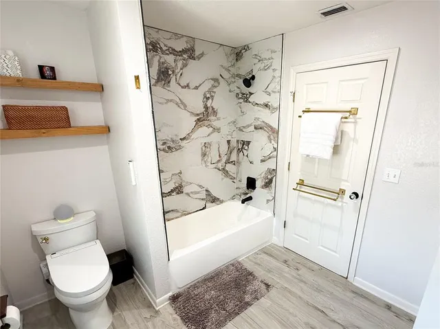 a bathroom with a toilet and shower