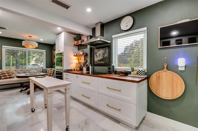 a room with furniture a flat screen tv and a large window