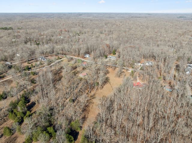 a view of a dry yard with houses