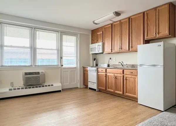 a kitchen with a sink a stove and cabinets