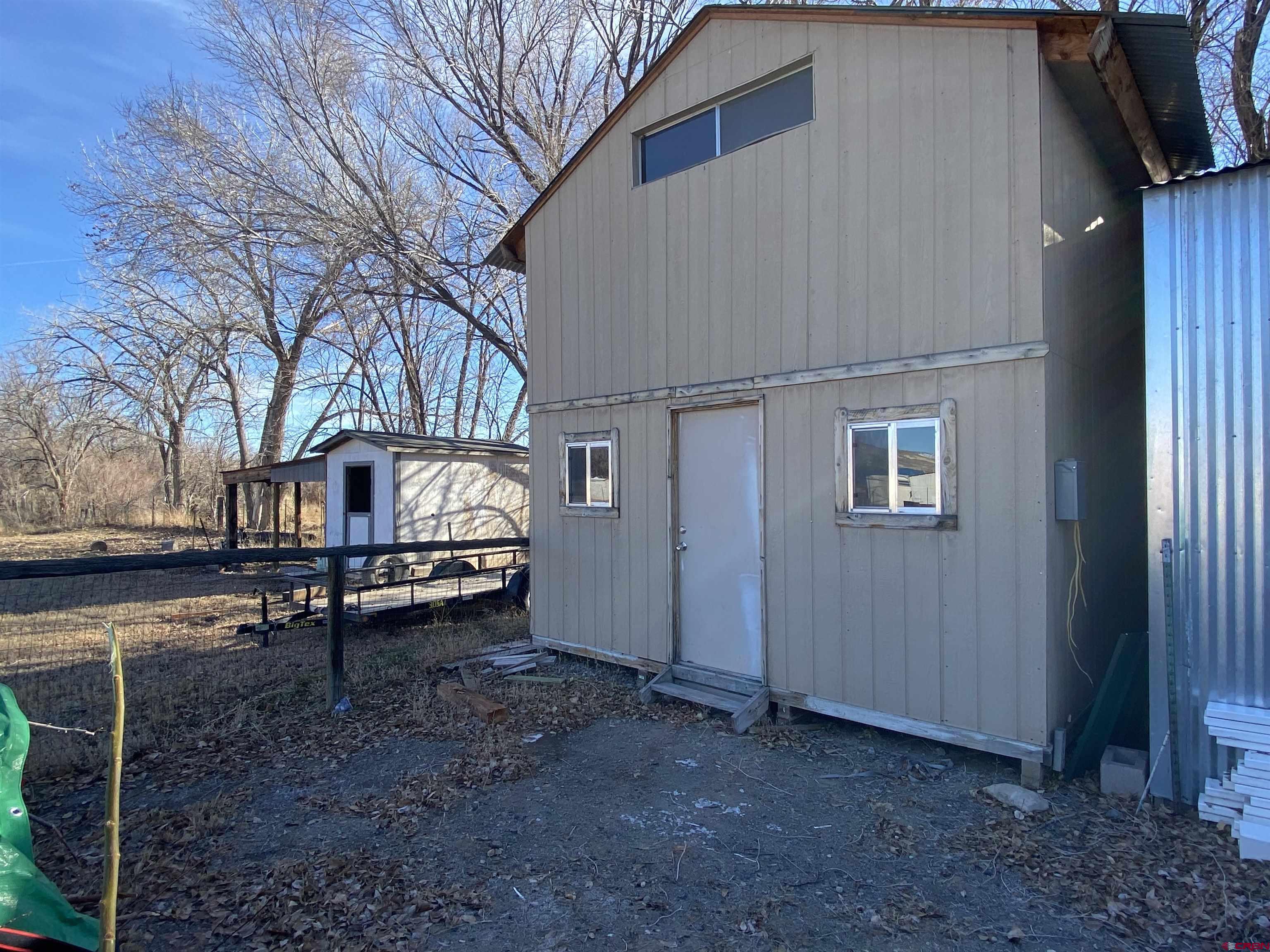 9728 2100th Road Austin, CO 81410 - Photo 3 of 17 a backyard of a house with table and chairs