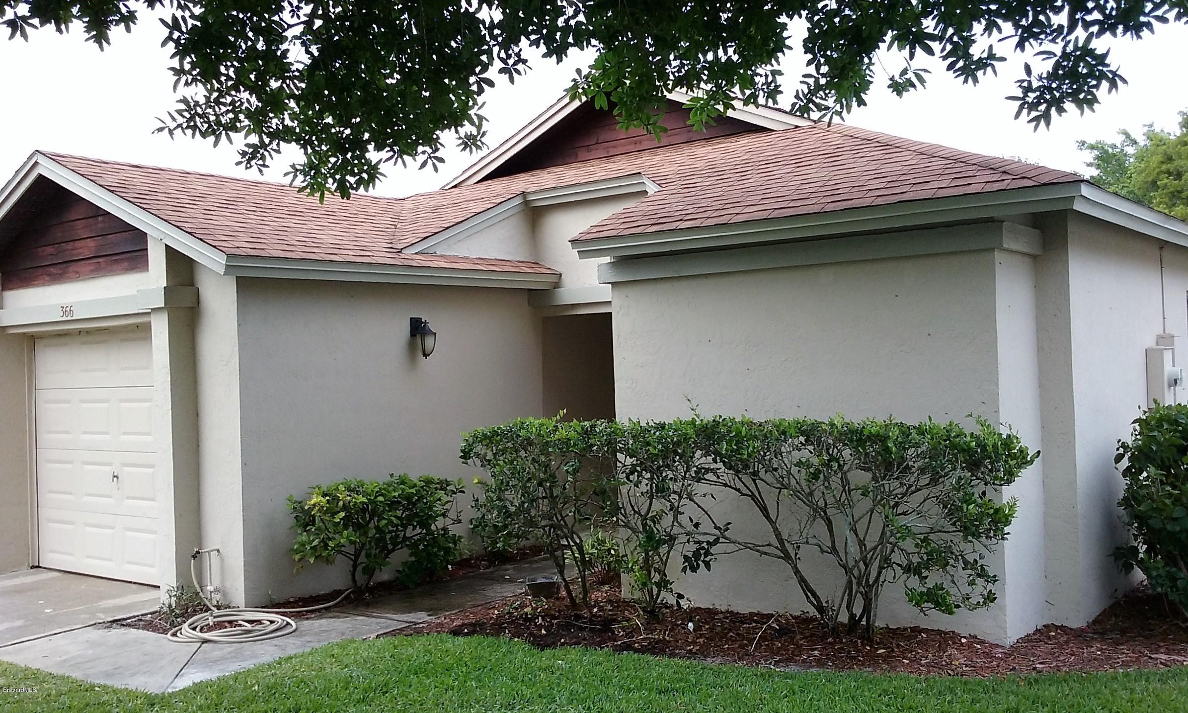 366 Myrtlewood Road Melbourne, FL 32940 - Photo 2 of 43 a small barn in front of a house with potted plants