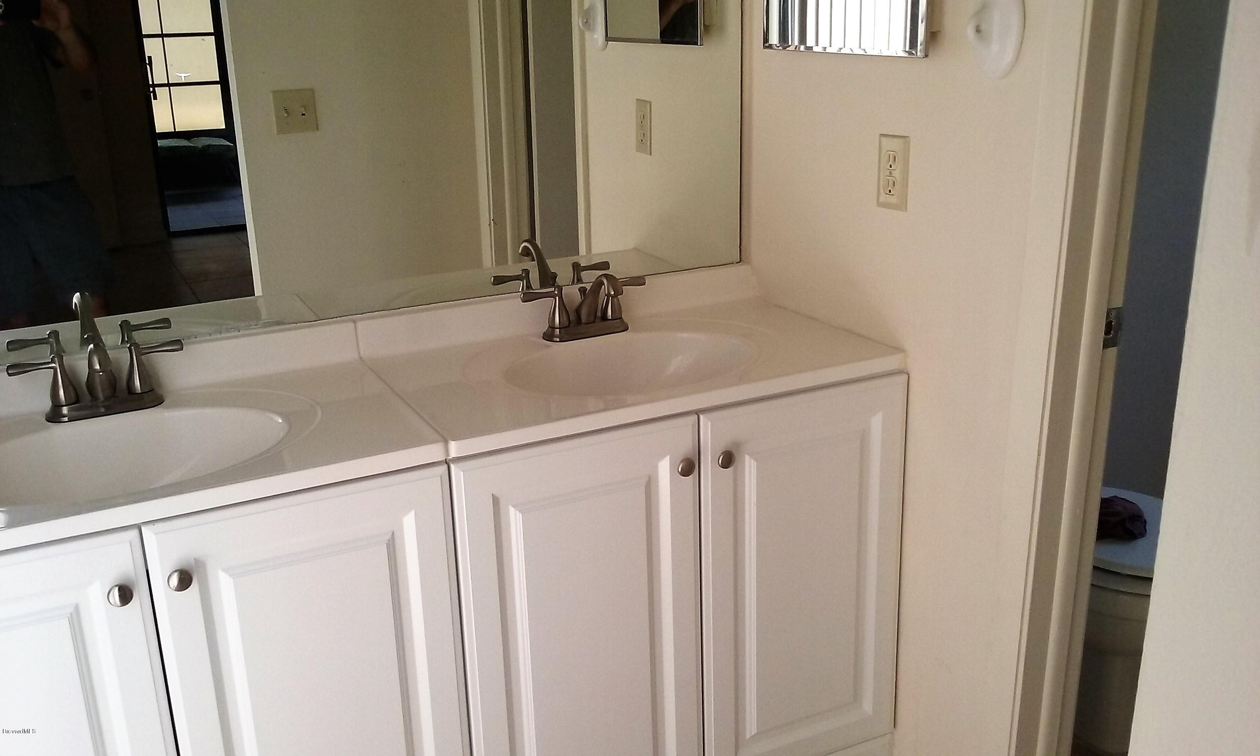 366 Myrtlewood Road Melbourne, FL 32940 - Photo 17 of 43 a bathroom with a sink and a mirror