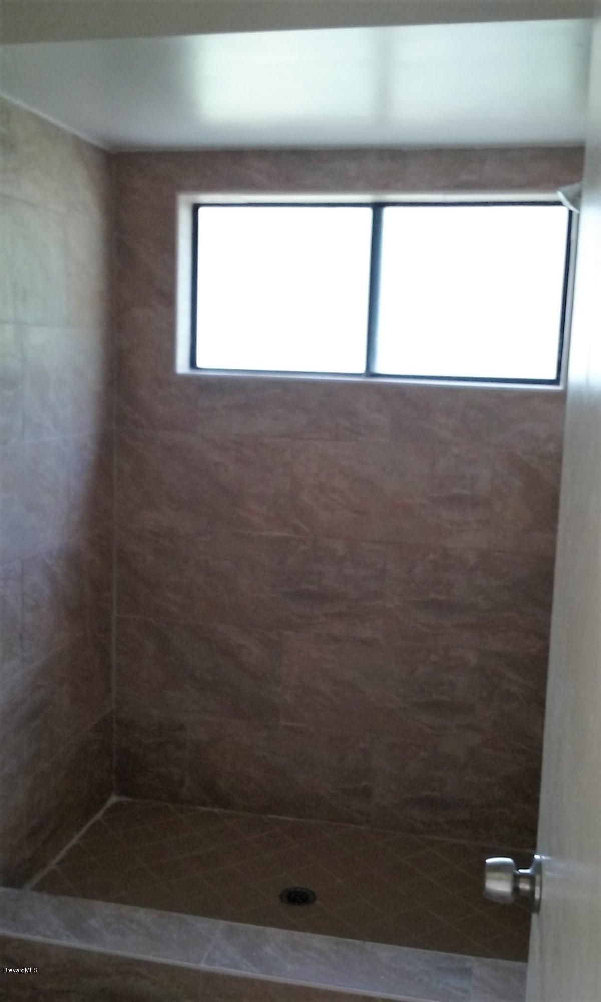 366 Myrtlewood Road Melbourne, FL 32940 - Photo 18 of 43 a bathroom with a window