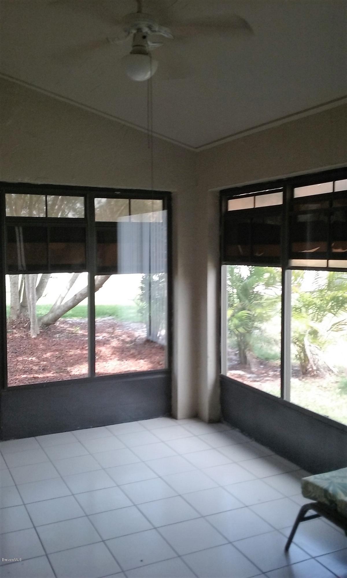 366 Myrtlewood Road Melbourne, FL 32940 - Photo 23 of 43 a view of large windows and a yard
