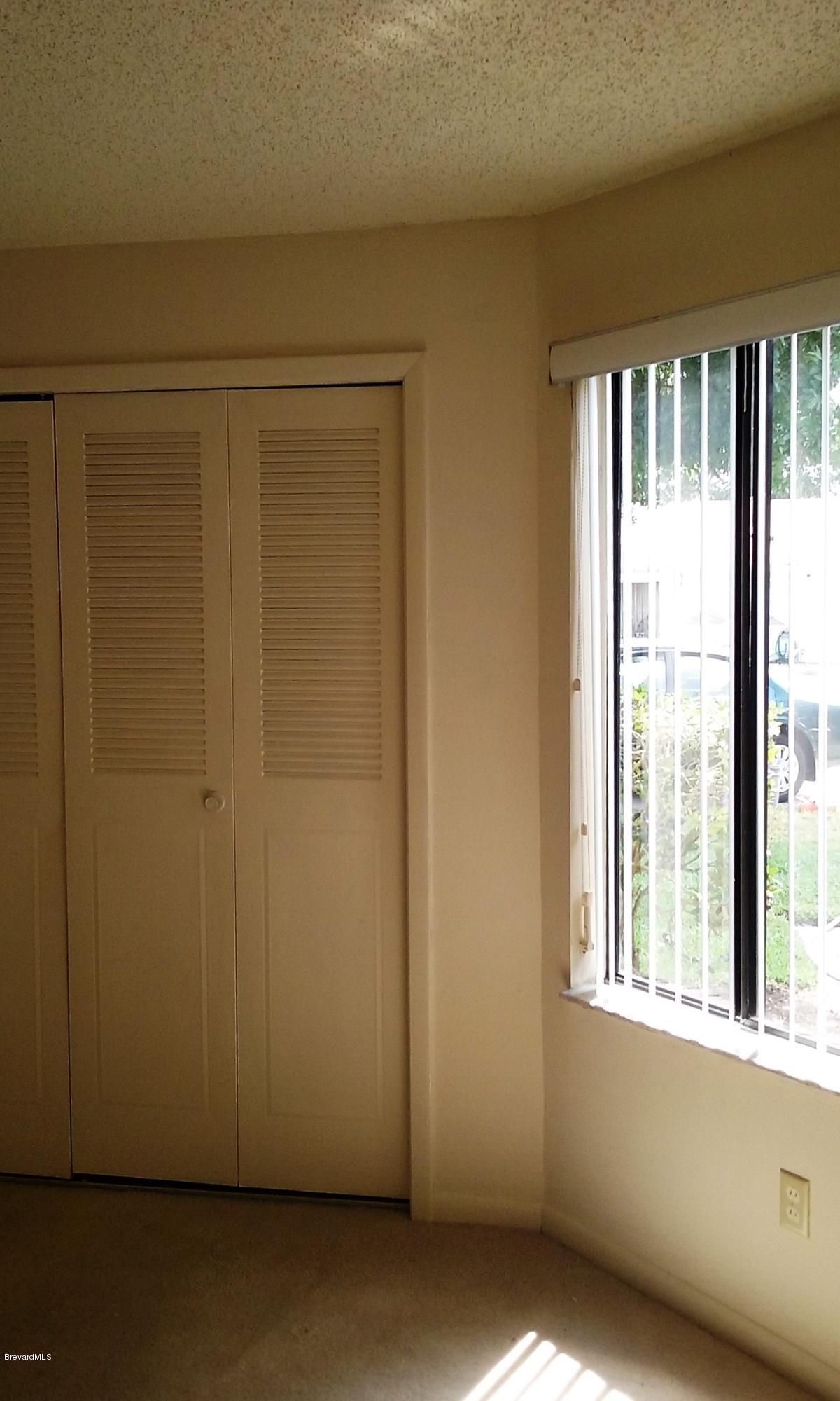 366 Myrtlewood Road Melbourne, FL 32940 - Photo 24 of 43 a view of an empty room with a window