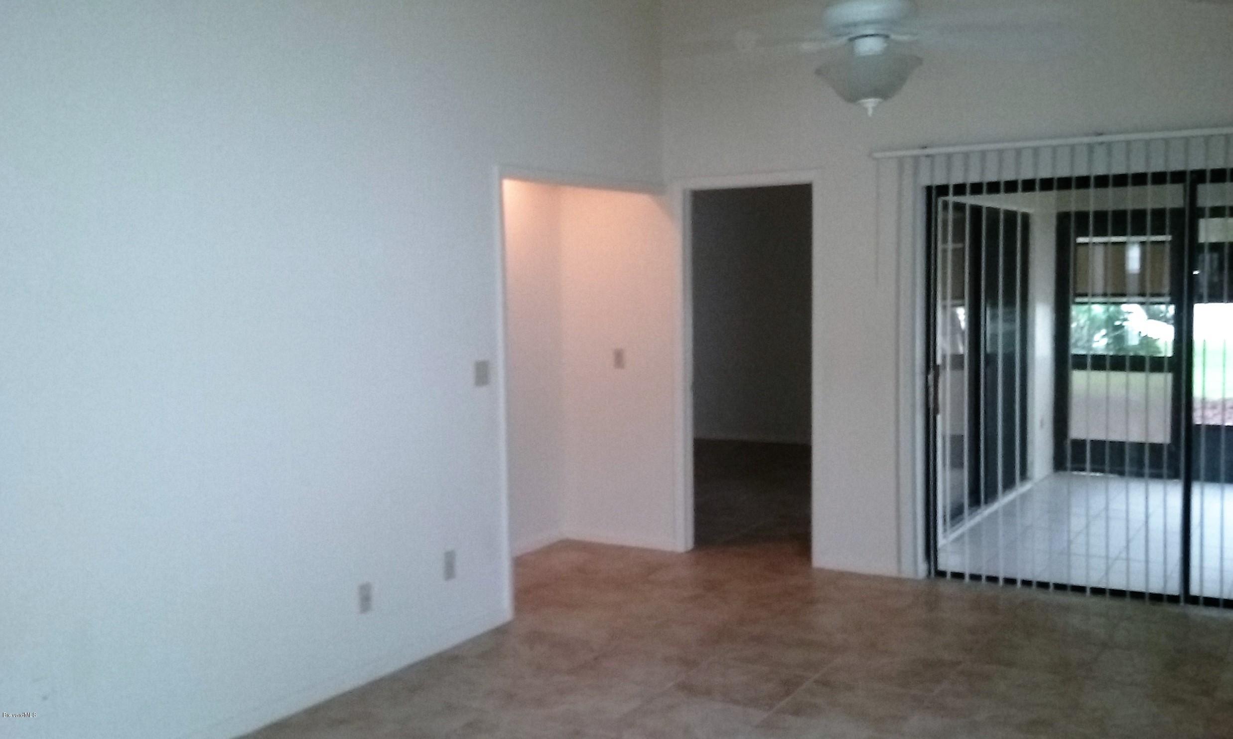 366 Myrtlewood Road Melbourne, FL 32940 - Photo 31 of 43 an empty room with wooden floor and windows