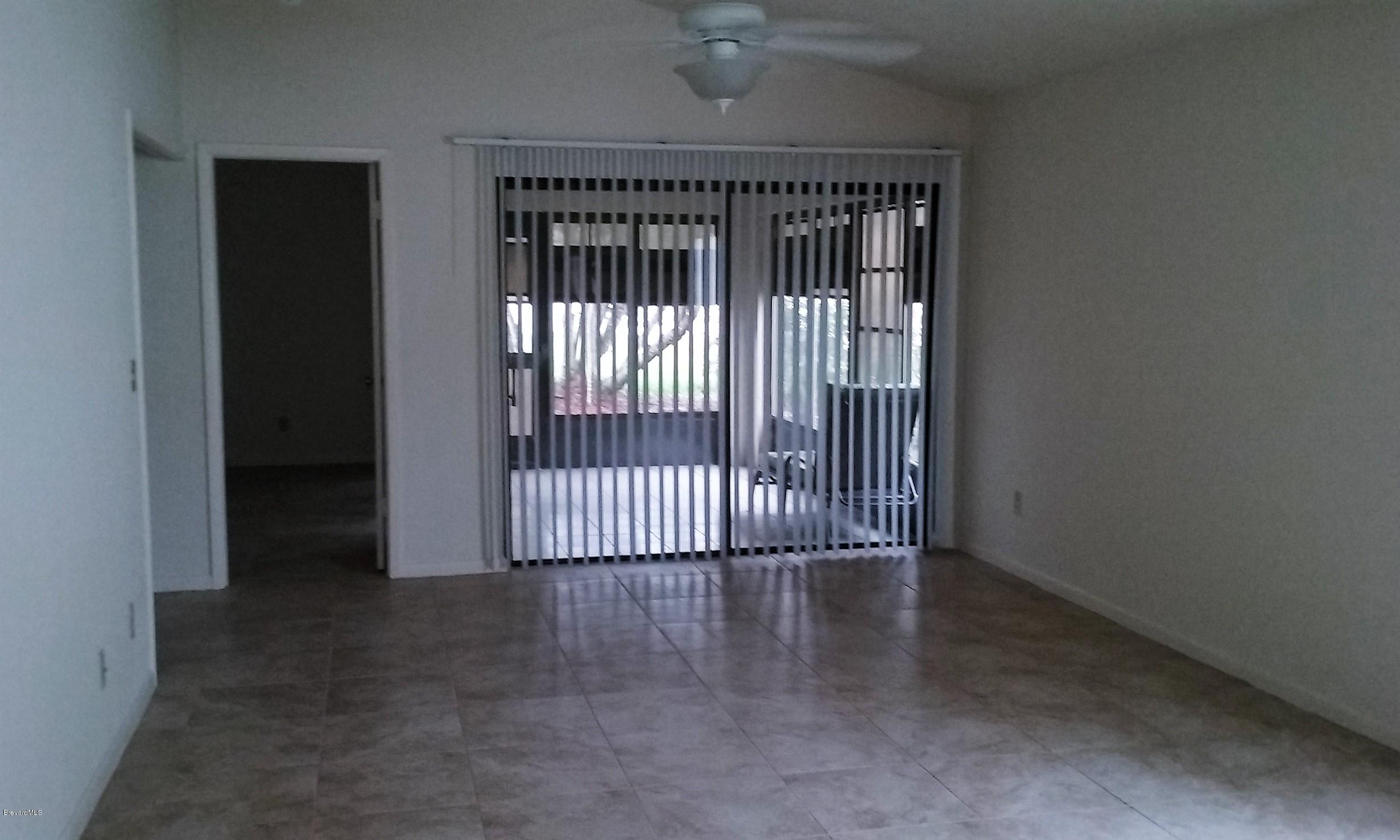 366 Myrtlewood Road Melbourne, FL 32940 - Photo 32 of 43 an empty room with wooden floor and windows