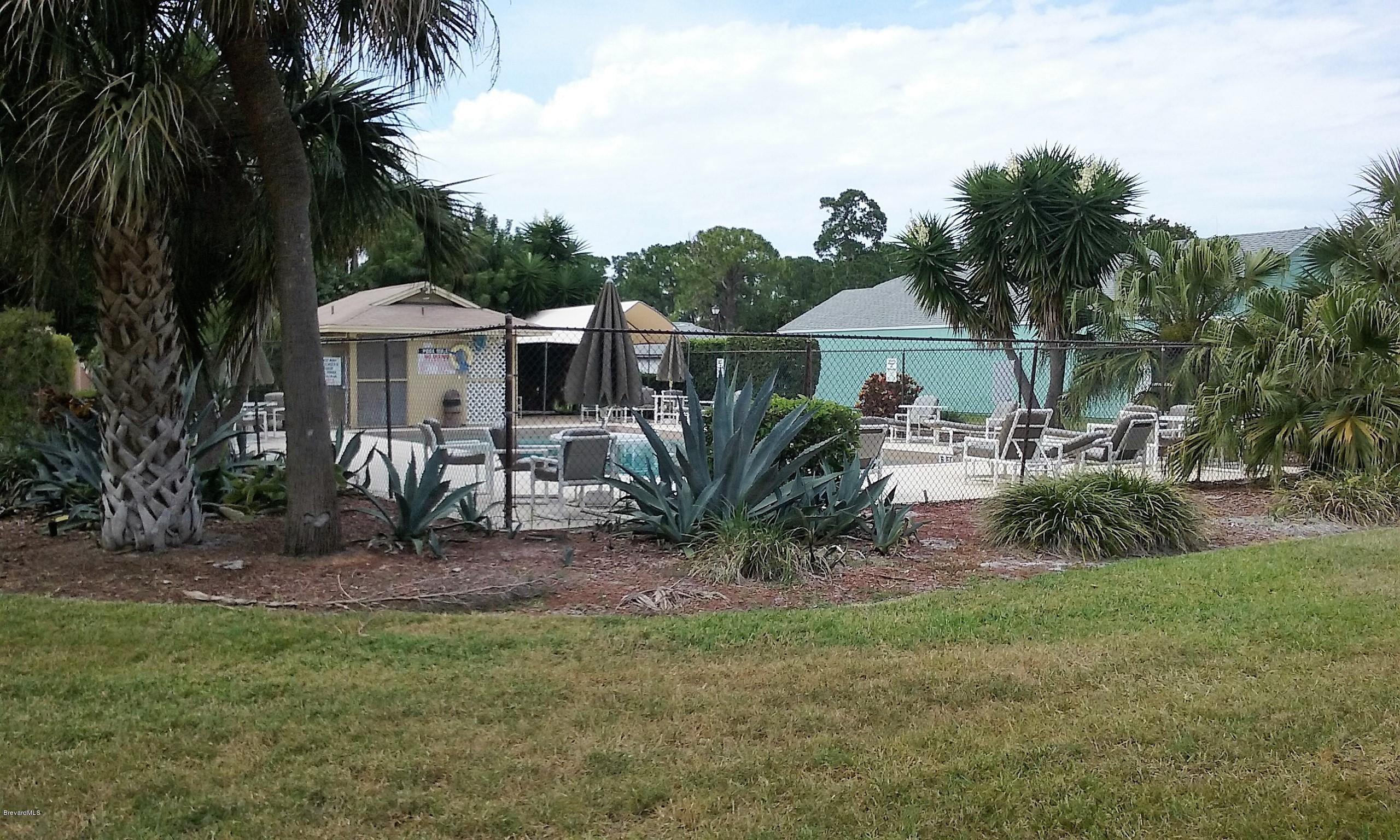 366 Myrtlewood Road Melbourne, FL 32940 - Photo 6 of 43 a front view of a house with a garden and trees