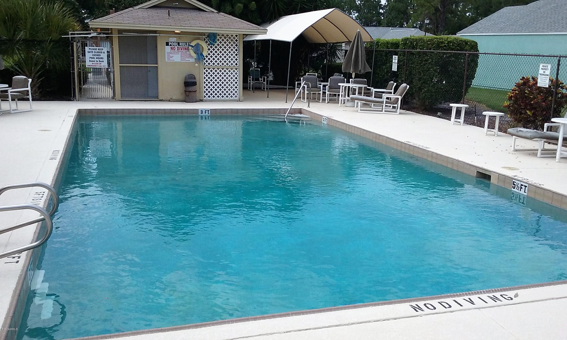 366 Myrtlewood Road Melbourne, FL 32940 - Photo 8 of 43 a swimming pool with outdoor seating and yard