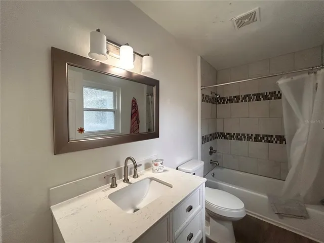 a bathroom with a sink toilet tub and shower