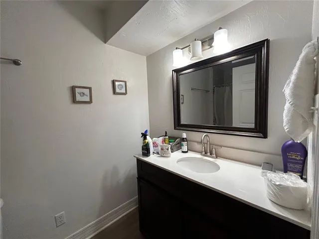 a bathroom with a sink vanity and a mirror