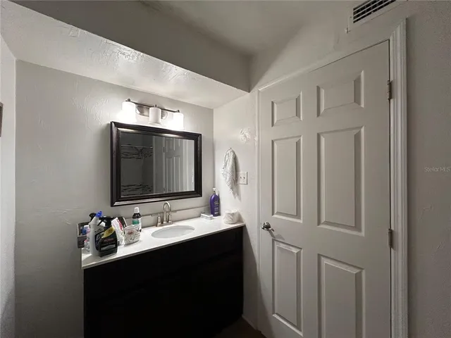 a bathroom with double sink and two mirror