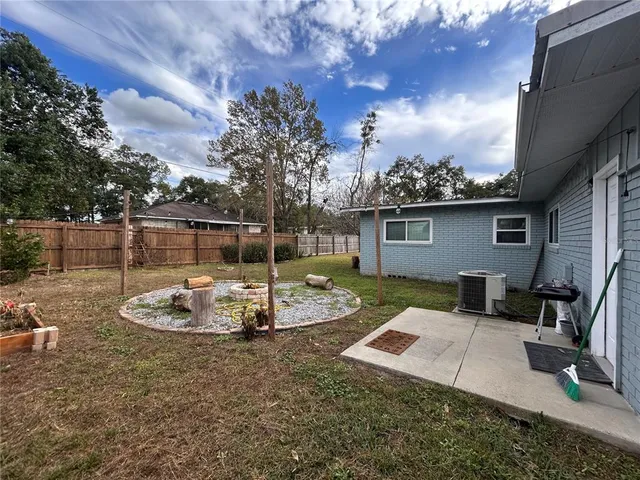 a view of a backyard with plants and a patio
