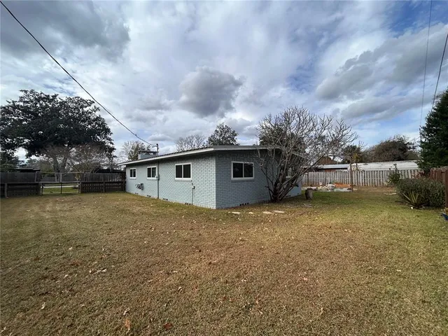 a view of backyard of house and car parked