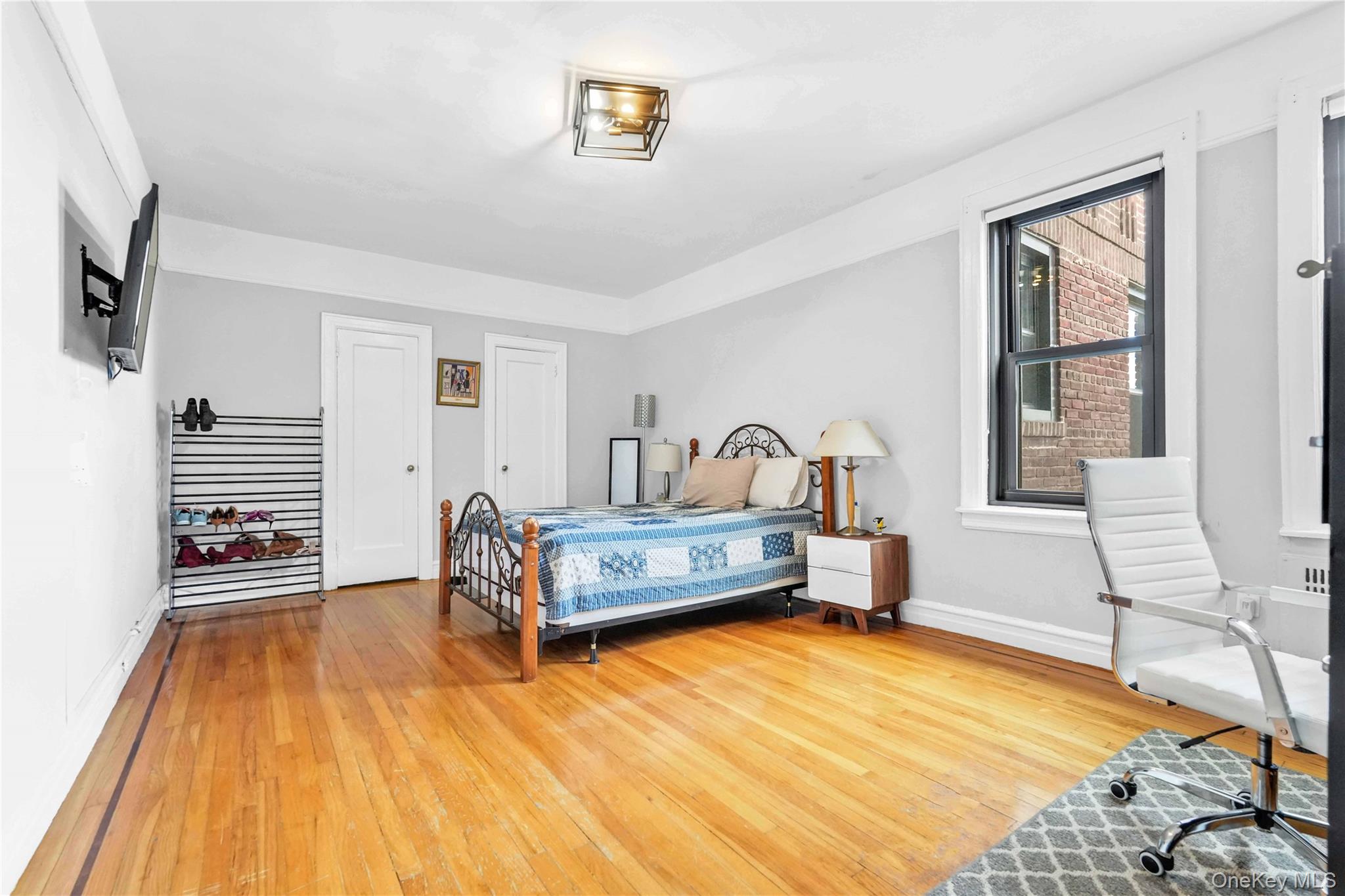 76-66 Austin Street, Unit 6F Queens, NY 11375 - Photo 5 of 11 a bedroom with furniture and a wooden floor