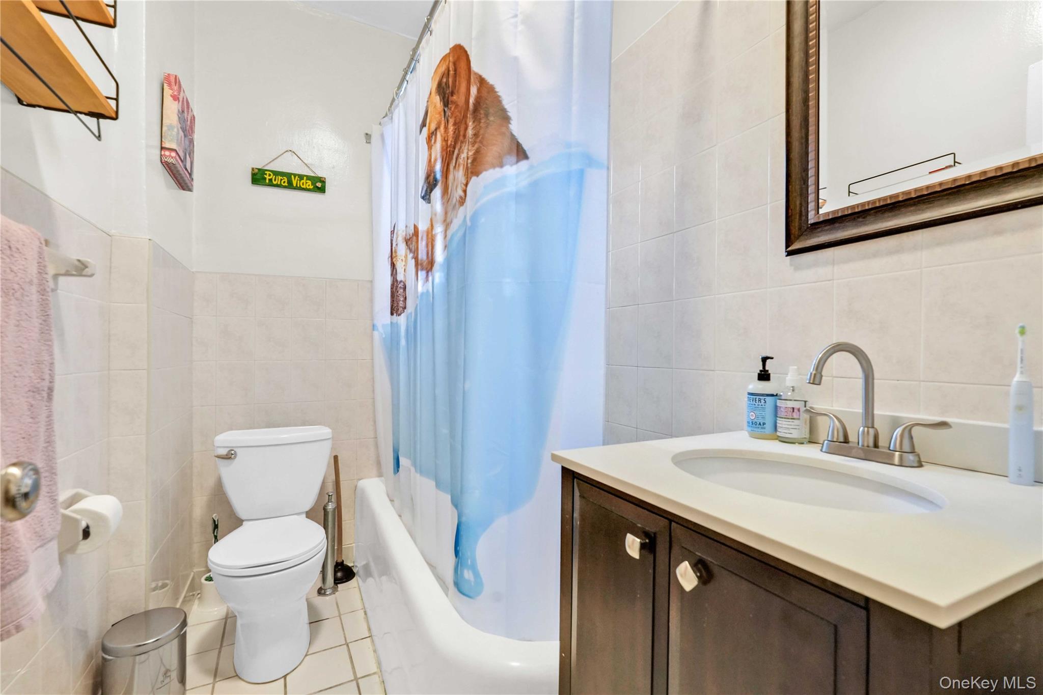 76-66 Austin Street, Unit 6F Queens, NY 11375 - Photo 7 of 11 a bathroom with a sink a toilet and a mirror
