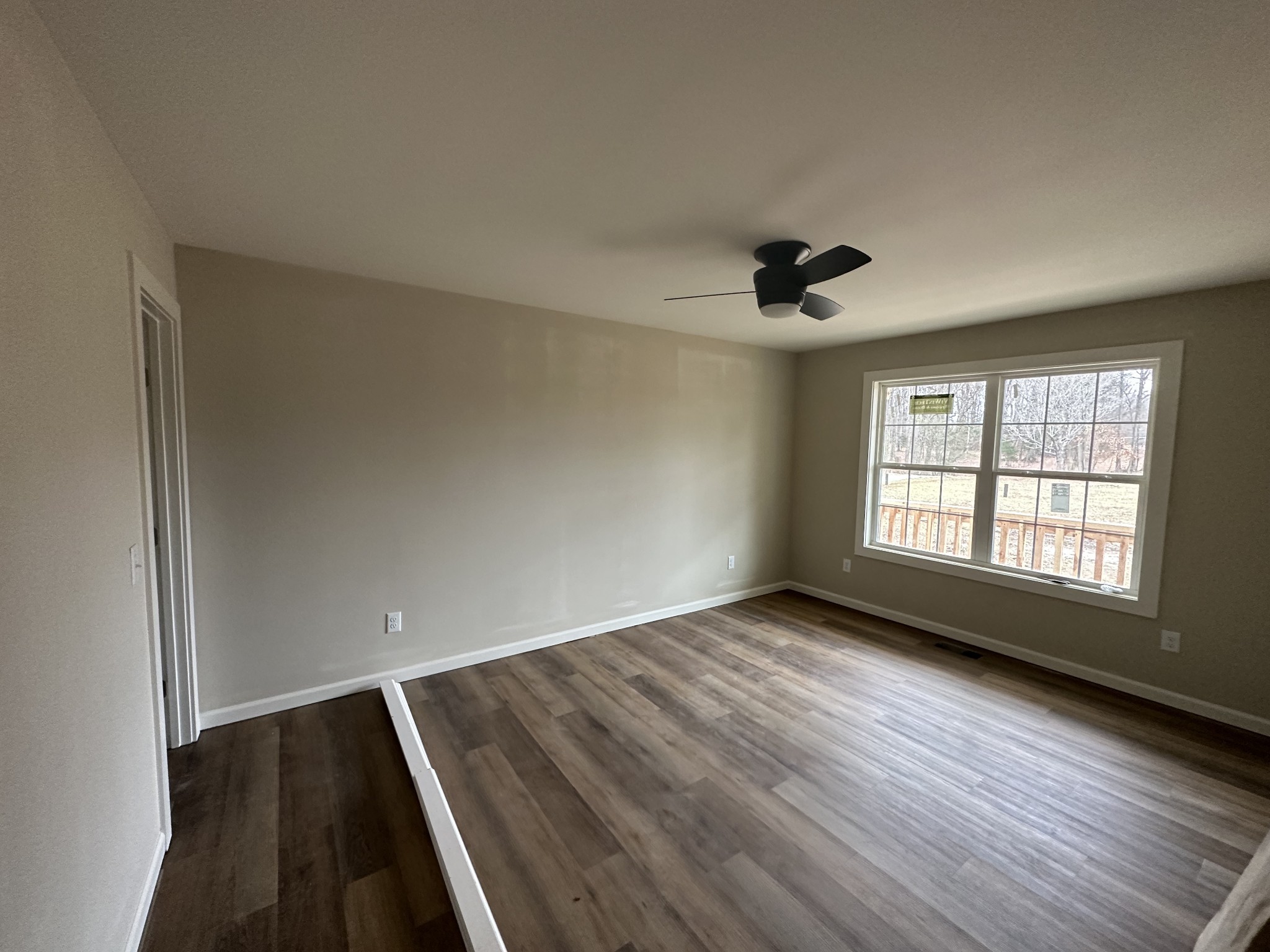 989 Mt Vernon Road Bethpage, TN 37022 - Photo 7 of 9 an empty room with wooden floor and windows