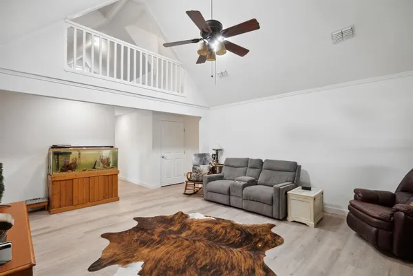 a living room with furniture and a wooden floor