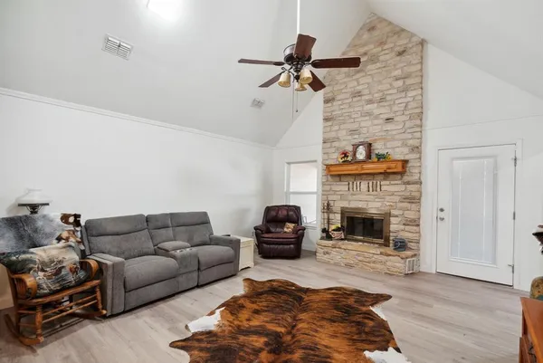 a living room with furniture and a fireplace