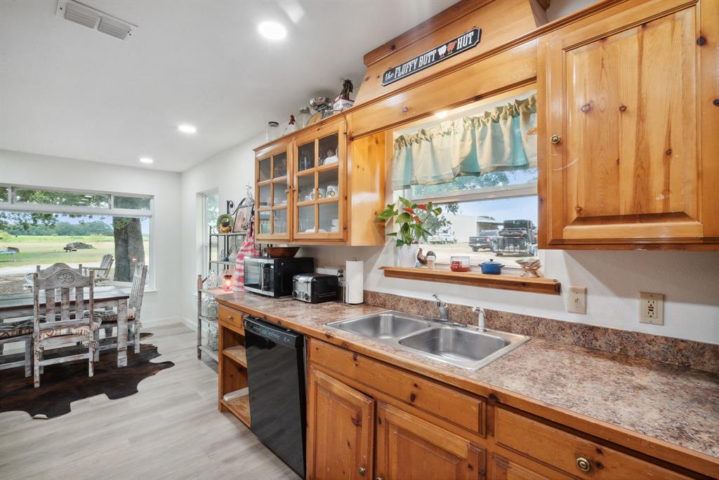 298 Townson Road Dublin, TX 76446 - Photo 27 of 40 a kitchen with stainless steel appliances granite countertop a sink and a stove