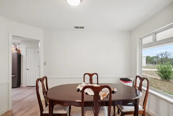 a view of a dining room with furniture and window