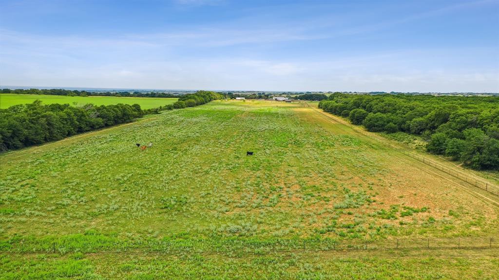 298 Townson Road Dublin, TX 76446 - Photo 4 of 40 a view of a big yard with an outdoor space and seating area
