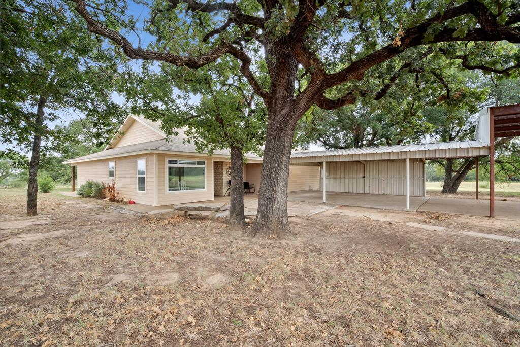 298 Townson Road Dublin, TX 76446 - Photo 8 of 40 front view of a house with a large tree and a large window