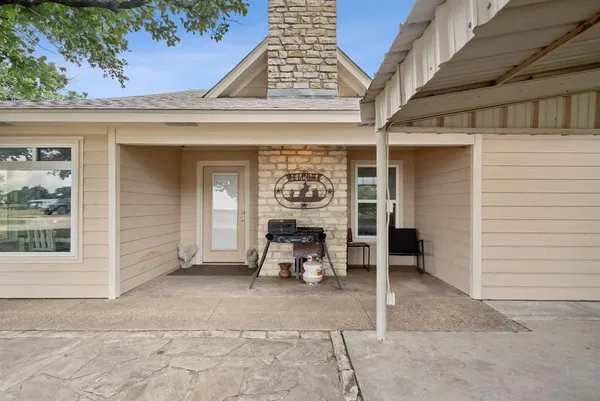 a view of a patio with table and chairs