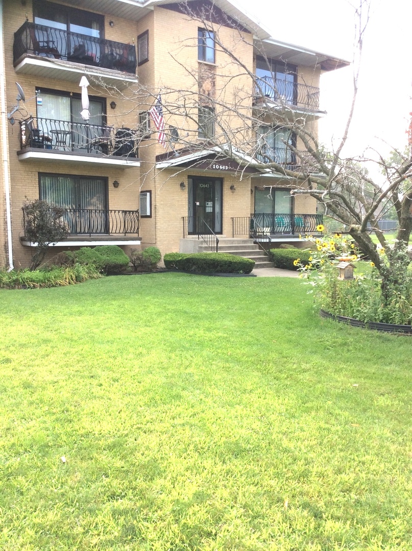 10643 Major Avenue, Unit 1C Chicago Ridge, IL 60415 - Photo 14 of 14 a front view of a building with a garden