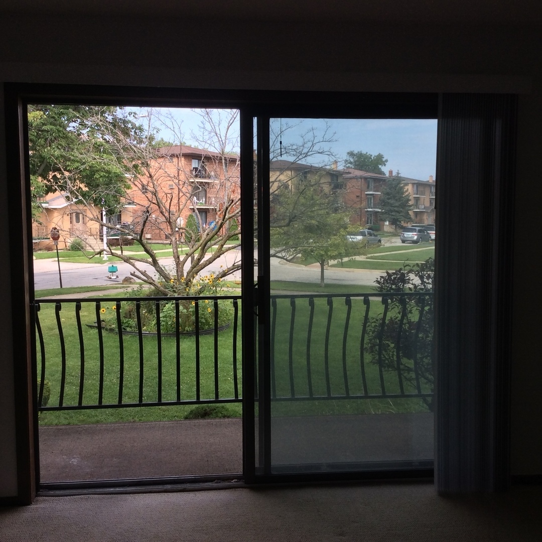 10643 Major Avenue, Unit 1C Chicago Ridge, IL 60415 - Photo 2 of 14 a view of a porch with a floor to ceiling window