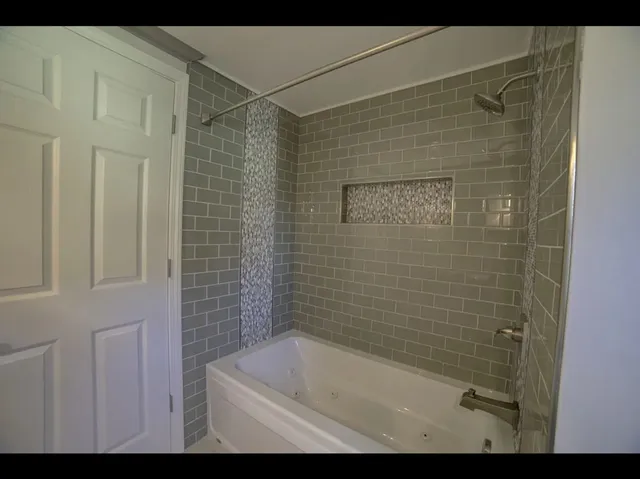 a bathroom with a shower and a bathtub