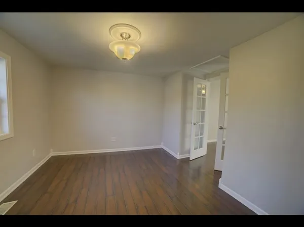 a view of room with wooden floor