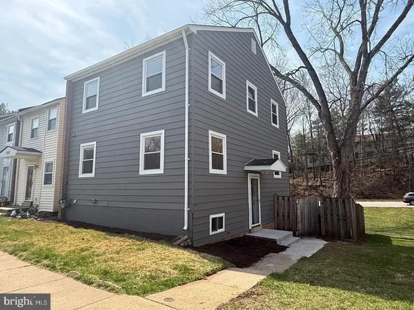 a view of a brick house with a yard