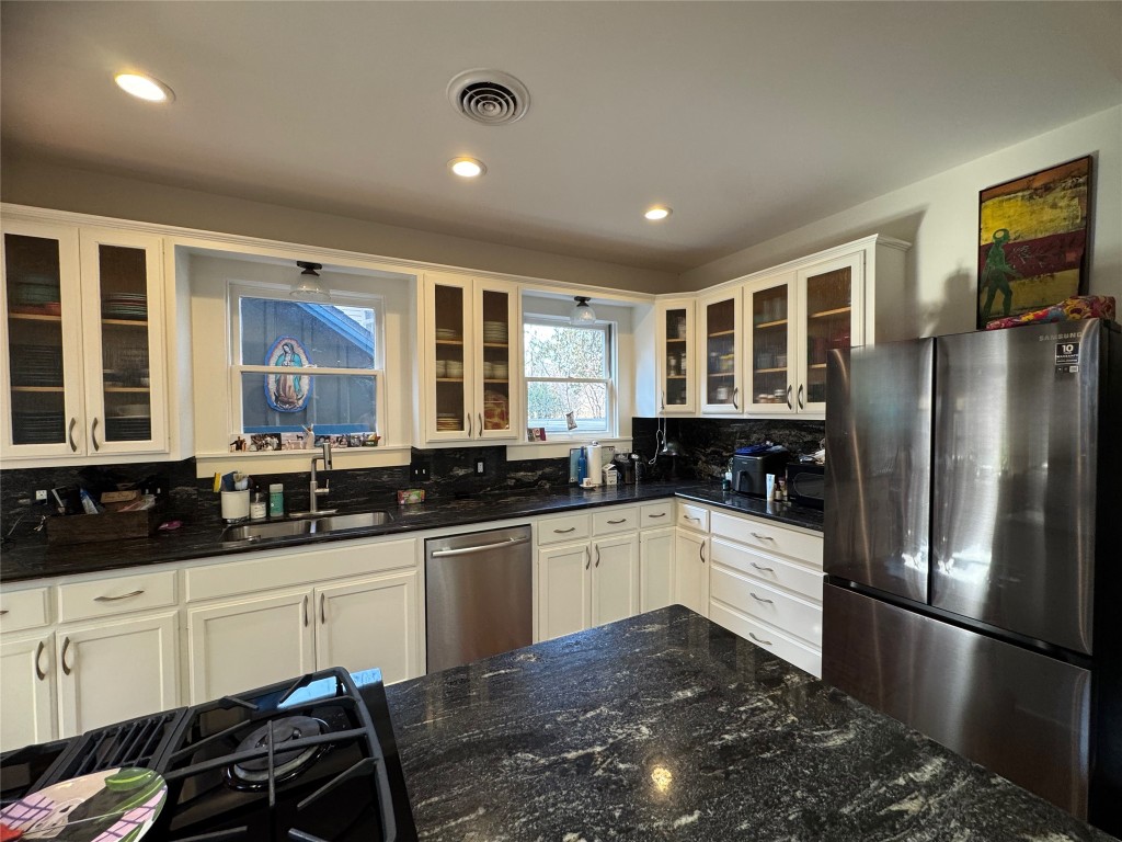 807 Leonard Street Austin, TX 78705 - Photo 11 of 32 a kitchen with stainless steel appliances granite countertop a sink stove and refrigerator