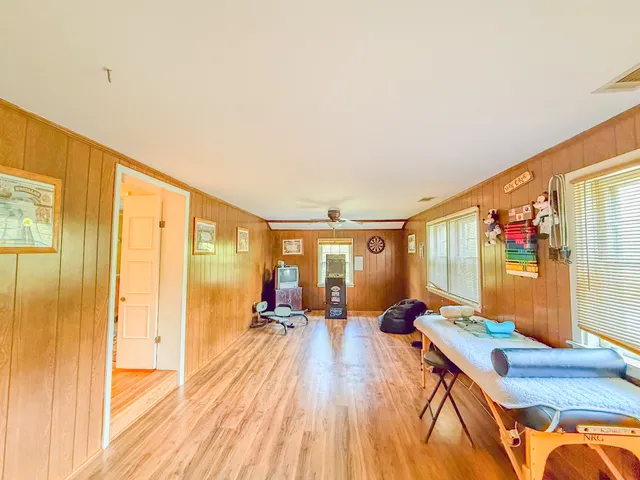 a view of a living room with furniture and a flat screen tv