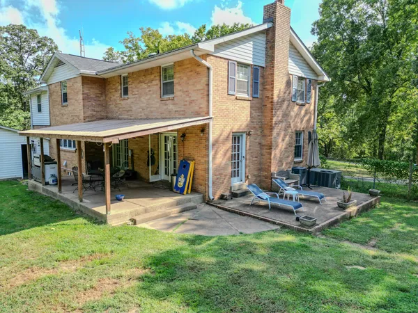 a aerial view of a house with yard and green space