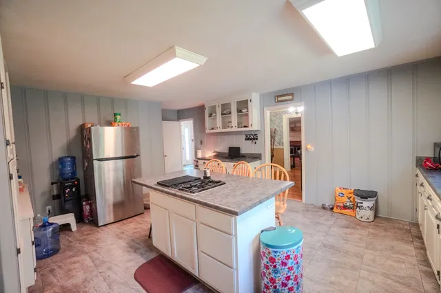 a kitchen with stove and cabinets